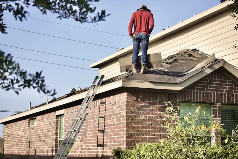 Professional roofer working on a residential roof in Hayestown
